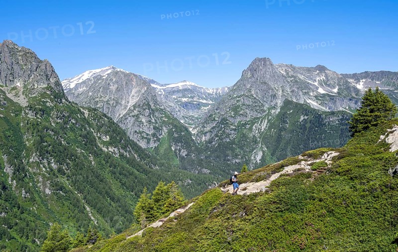 Mountaineer on hiking trail to Aiguillette des Posettes, mountain panorama with summit Mont Bues and Pointe de la Terasse, Chablais Alps, Chamonix, Haute-Savoie, France, Europe