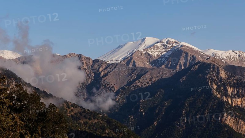 Mountains with snow-covered peaks and some clouds in a calm, natural atmosphere, Omalos Plateau, entrance to Samaria Gorge, Lefka Ori, White Mountains, mountain massif, west, Crete, Greece, Europe