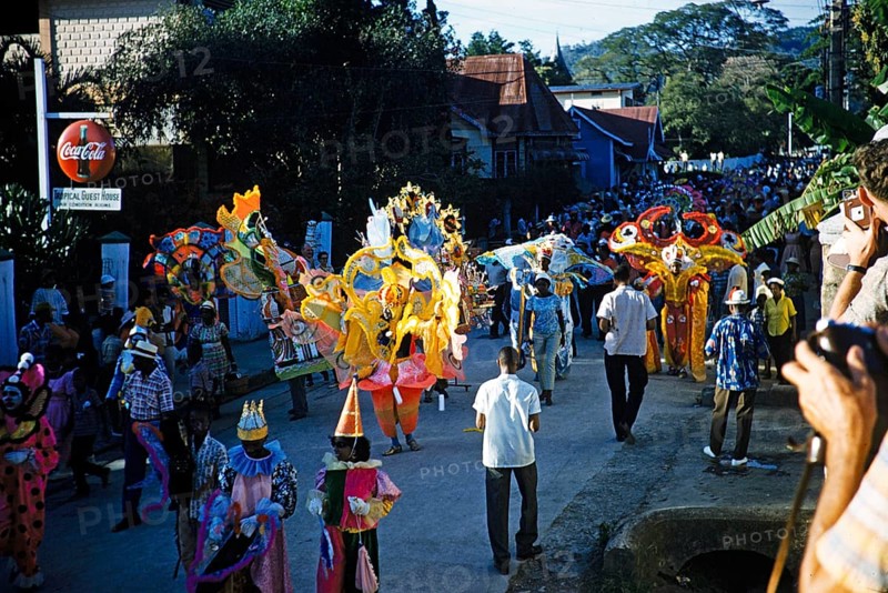 People in colourful costumes at the carnival parade, Port of Spain, Trinidad 1963 with the title Fancy Clown