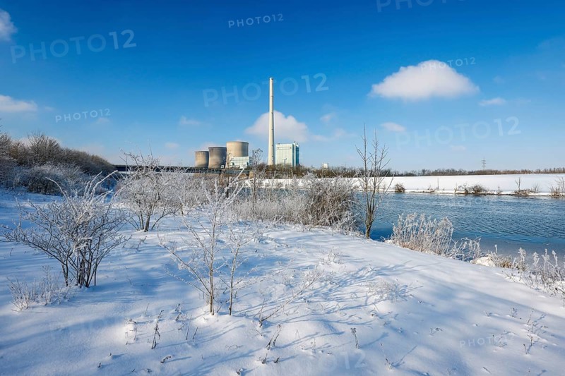 Hamm, North Rhine-Westphalia, Germany - Sunny winter landscape in the Ruhr area, ice and snow on the river Lippe, behind the RWE gas-fired power station Gersteinwerk