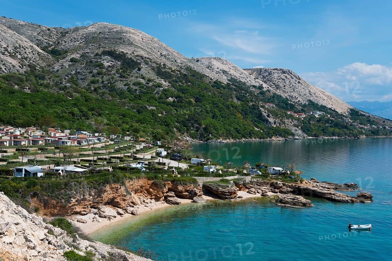 Coastal landscape with rocky mountains and clear blue water, lined with small houses under a sunny sky, campsite near Stara Baška, Stara Baska, Altweschke, Primorje-Gorski kotar, Croatia, Europe