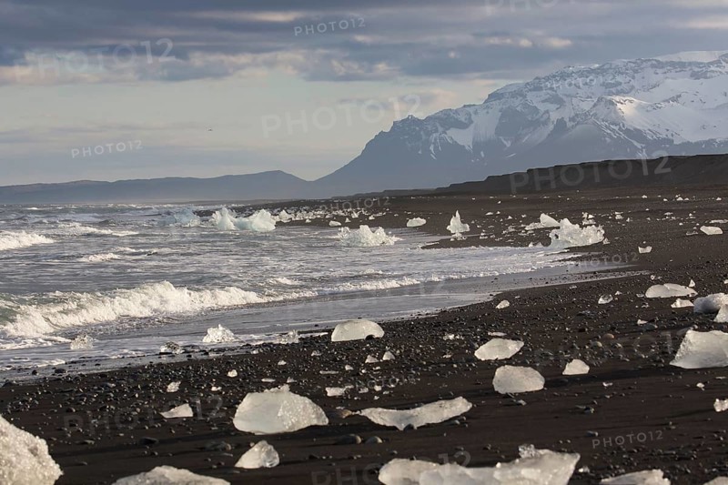 Little icebergs and crushed ice on the black beach at Joekulsarlon glacial lake