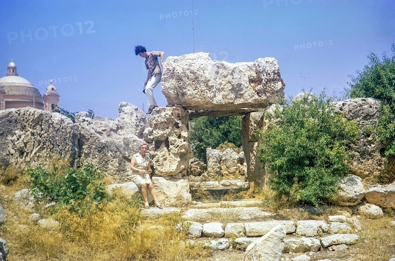 Neolithic temples of Skorba prehistoric archaeological site, Mgarr, Malta, Europe 1971 young man climbing on stones, Europe