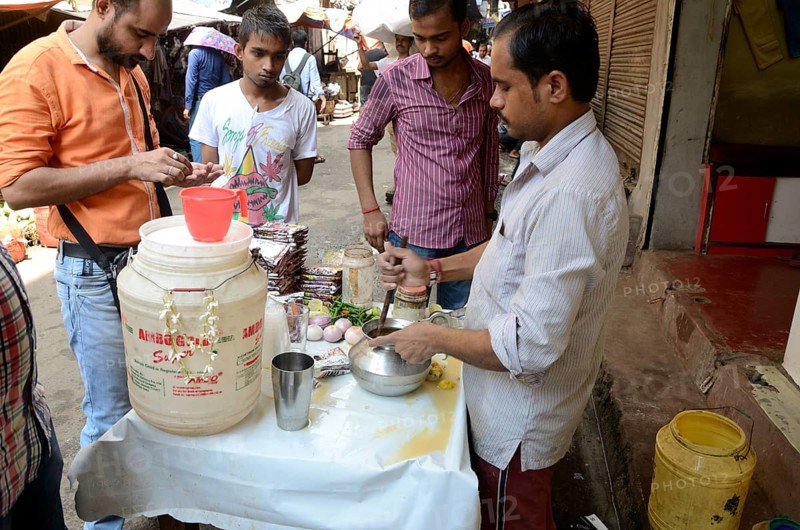 Man churning lassi, Kolkata, West Bengal, India, Asia