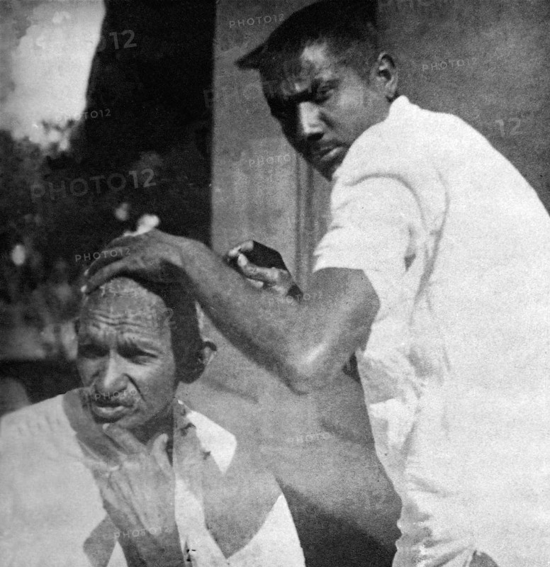 Mahatma Gandhi getting shaved during the salt march, March 1930 - MODEL RELEASE NOT AVAILABLE