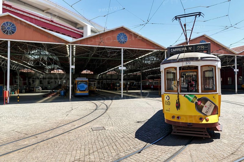 Historic yellow tram, Eléctrico, line 28 in front of tram depot and repair shop, Lisbon, Portugal, Europe