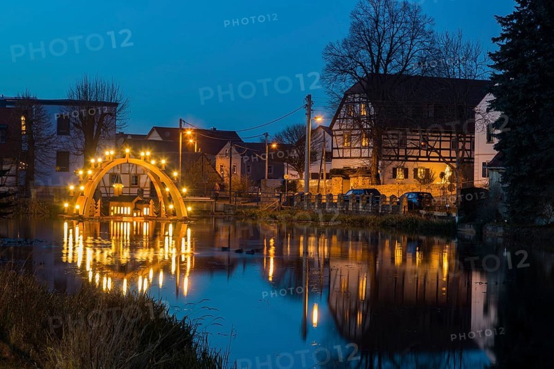 Floating candle arch in the village pond of Bärnsdorf near Moritzburg. The arch is 4.5m high, almost 8m wide and was built by local craftsmen as a special decoration for the local Christmas market