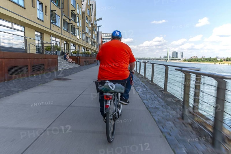 Cycling from the first-person perspective on a shared footpath and cycle path in Cologne, North Rhine-Westphalia, Germany, Europe