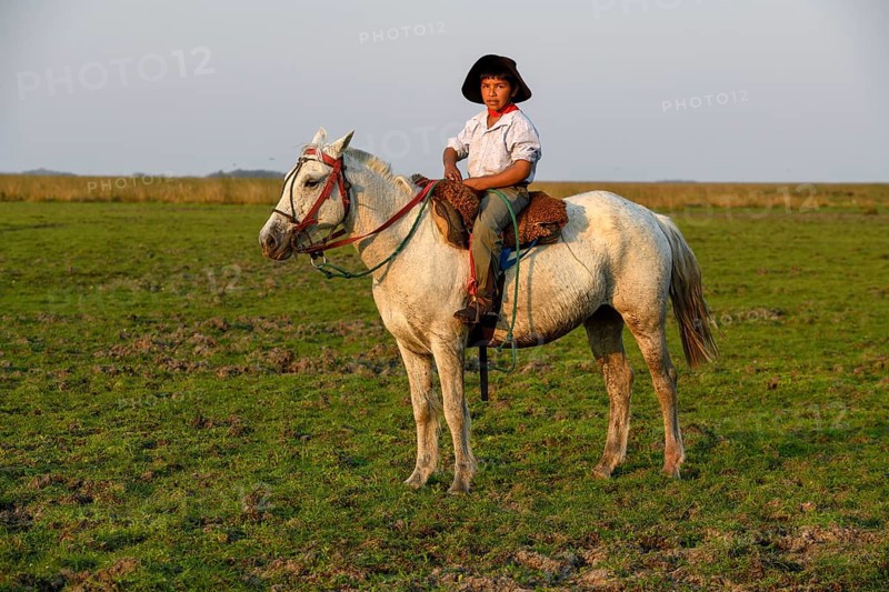 Young Gaucho on his horse at Puesto Mingo, Esteros del Iberá, near Concepción del Yaguareté Corá, Corrientes Province, Argentina, South America