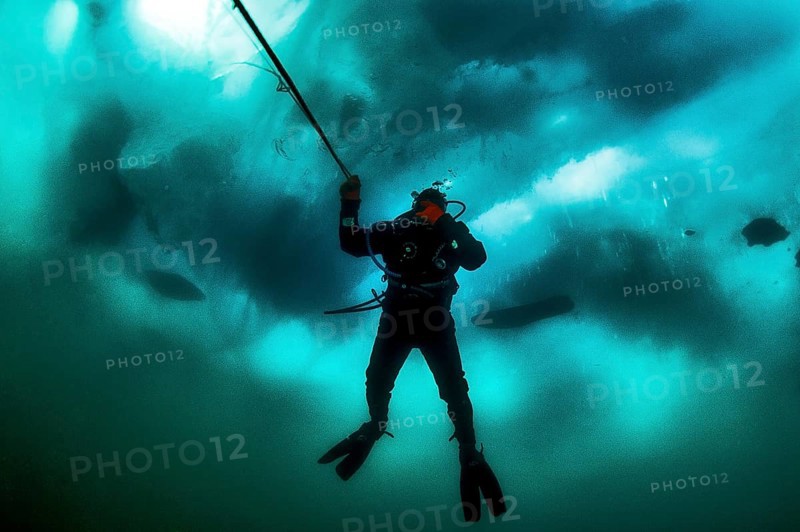 Scuba diver under ice, Lake Baikal, Olkhon Island, Pribaikalsky National Park, Irkutsk Province, Siberia, Russia, Europe