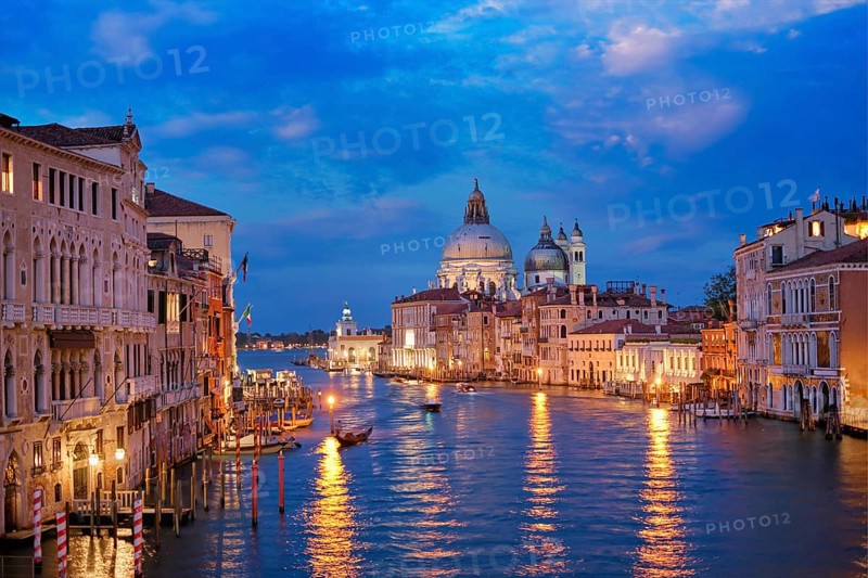 View of Venice Grand Canal with boats and Santa Maria della Salute church in the evening from Ponte dell'Accademia bridge. Venice, Italy, Europe