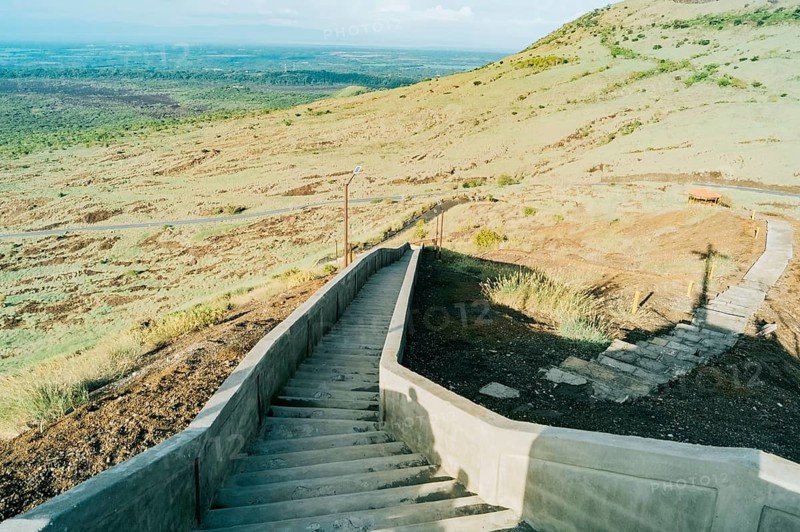 High angle of long concrete stairs outside with nature background. Long concrete stairs on a beautiful hill. Long stairs leading to the viewpoint of the Masaya volcano, Nicaragua, Central America