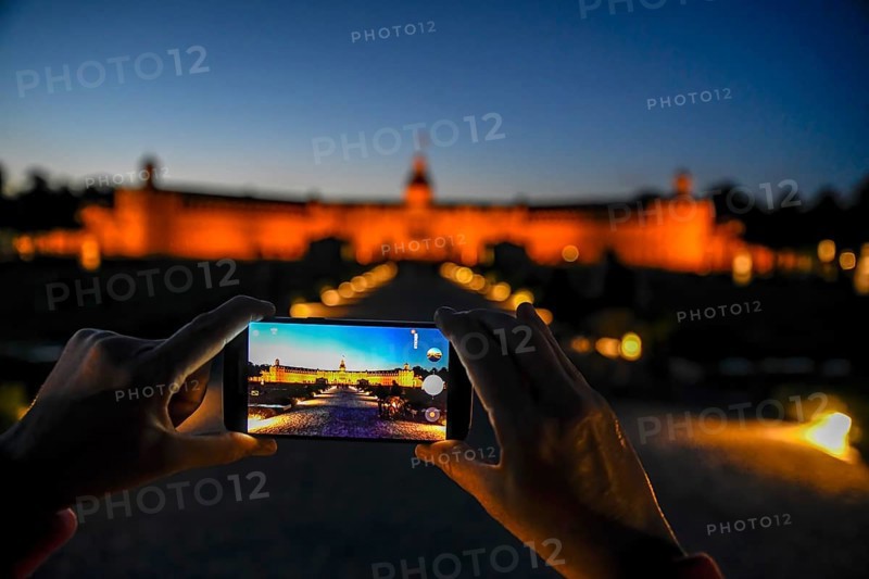 Karlsruhe castle at dusk in the display of a mobile phone, Karlsruhe, Baden-Württemberg, Germany, Europe