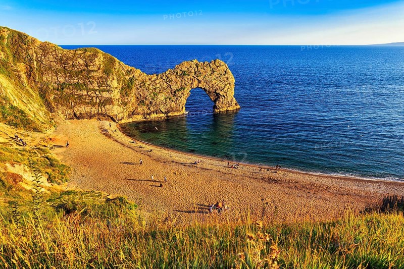 Coastline with bathing beach at Durdle Door, limestone rock bridge, UNESCO World Heritage Site, Dorset landmark, England, United Kingdom, Europe