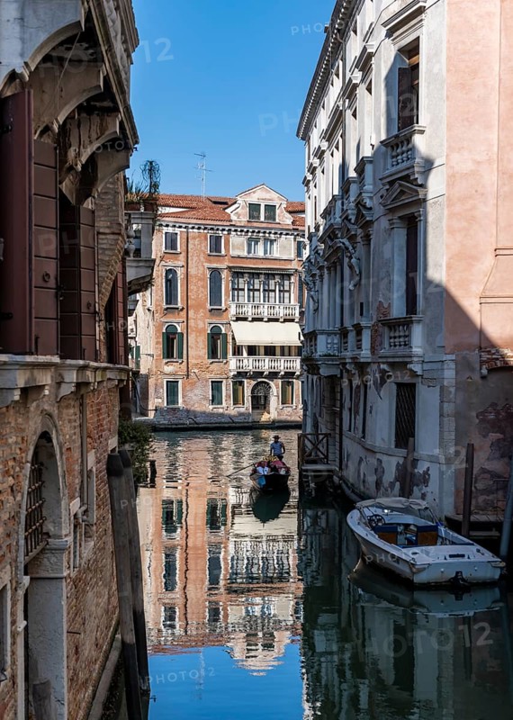 Gondola travelling through a small canal, reflection, Venice, Italy, Europe