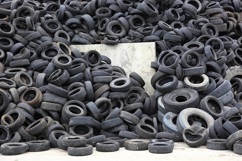 Old car tyres lie on stockpiles for recycling