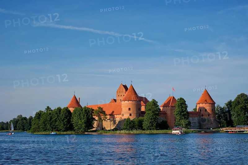 Trakai Island Castle in lake Galve with boats and yachts in summer day with beautiful sky, Lithuania. Trakai Castle is one of major tourist attractions of Lituania