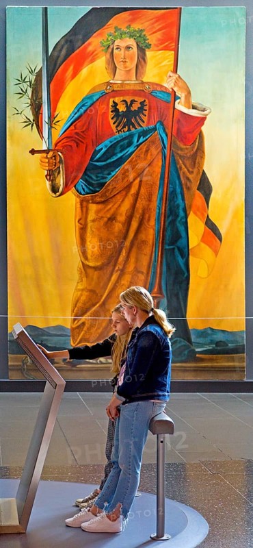 Two woman at a screen in front of the painting of Germania by Philipp Veit, Haus der Geschichte, Bonn, North Rhine-Westphalia, Germany, Europe