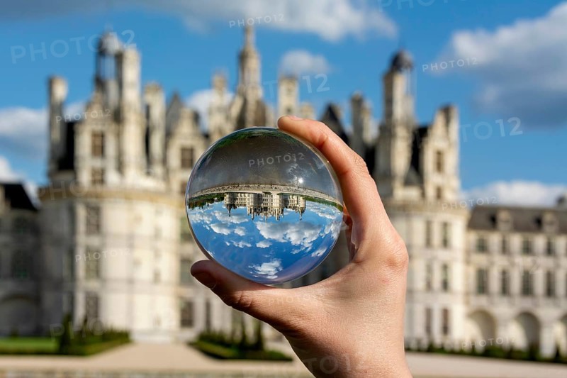 View of the Chateau de Chambord through a transparent ball. Loir-et-Cher department, Centre-Val de Loire, France, Europe