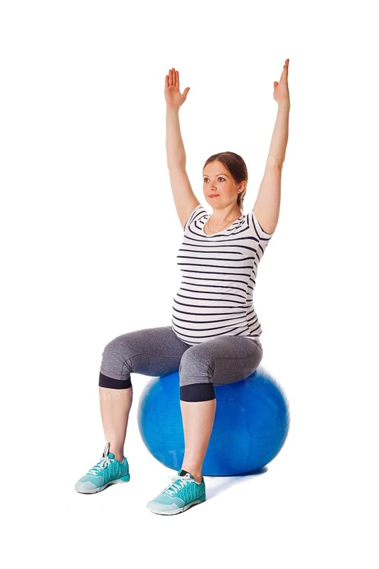 Pregnancy exercise concept, pregnant woman doing exercises with exercise ball isolated on white background