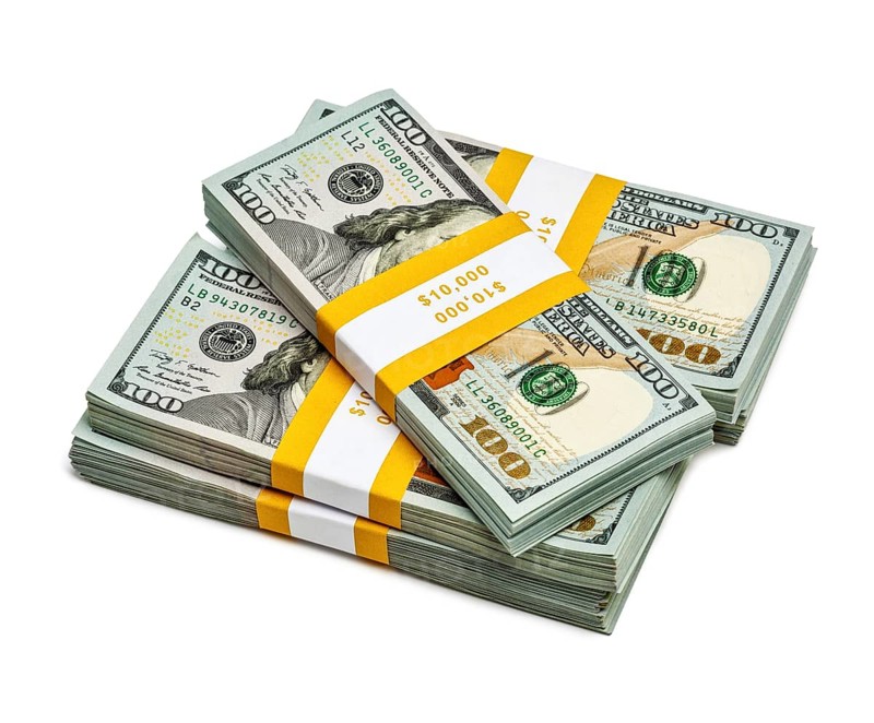 Creative business finance making money concept, stack of bundles of 100 US dollars 2013 edition banknotes bills isolated on white