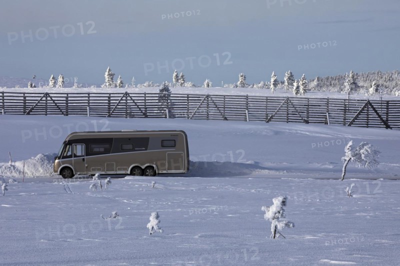 Winter camping with camper van on a mountain near Saariselkä, Lapland, Finland, Europe