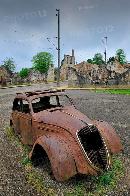 Burnt-out Peugeot 202 of family doctor Desourteux on the street The burnt-out village of Oradour-sur-Glane was destroyed on 10 June 1944 when 642 of its inhabitants, including woman and children, were massacred by a German Waffen SS company