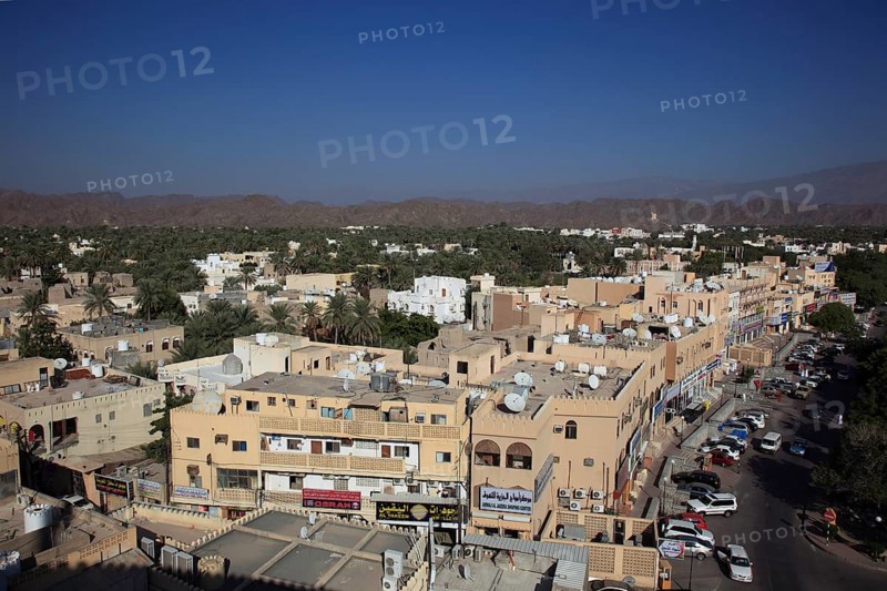 View of the city and the palm gardens of Nizwa from the fort. Nizwa is the centre of the Omani heartland. The oasis town lies on the southern edge of the Hajar Mountains near the Jabal al-Achdar, the highest mountain range in Oman