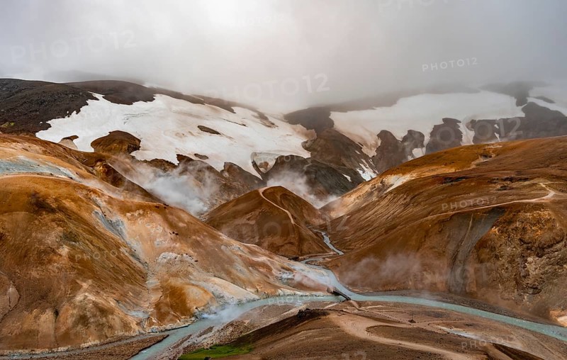 Bridge and steaming streams between colourful rhyolite mountains and snowfields, Hveradalir geothermal area, Kerlingarfjöll, Icelandic Highlands, Iceland, Europe