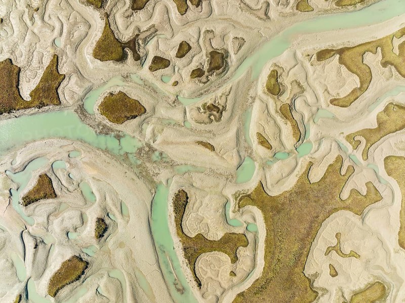 Network of channels and streams at low tide, in the marshland of the Bahía de Cádiz, aerial view, drone shot, Cádiz province, Andalusia, Spain, Europe