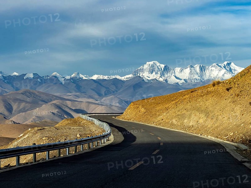 Road with a view of the mountain range of the eight-thousand metre peaks, Tibet, China, Asia