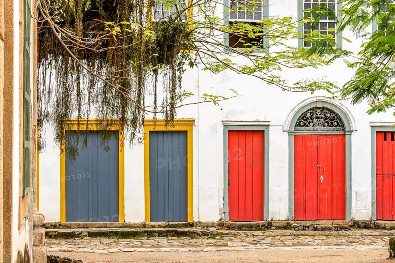 Facade of colorful houses in colonial style on the streets of the city of Paraty on the coast of the state of Rio de Janeiro, Brasil