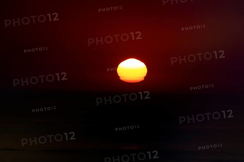 Refraction and reflection at sunset, deformation, unusual deformation in haze, Bassin d'Arcachon, Bay of Biscay, France, Europe