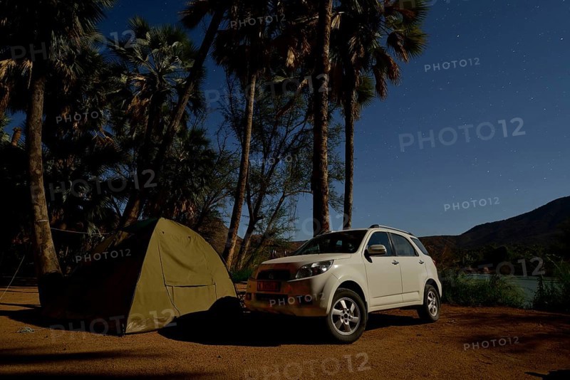 Tent and safari vehicle at night on a campsite near Epupa Falls, Epupa, Kaokoland, Kunene, Namibia, Africa