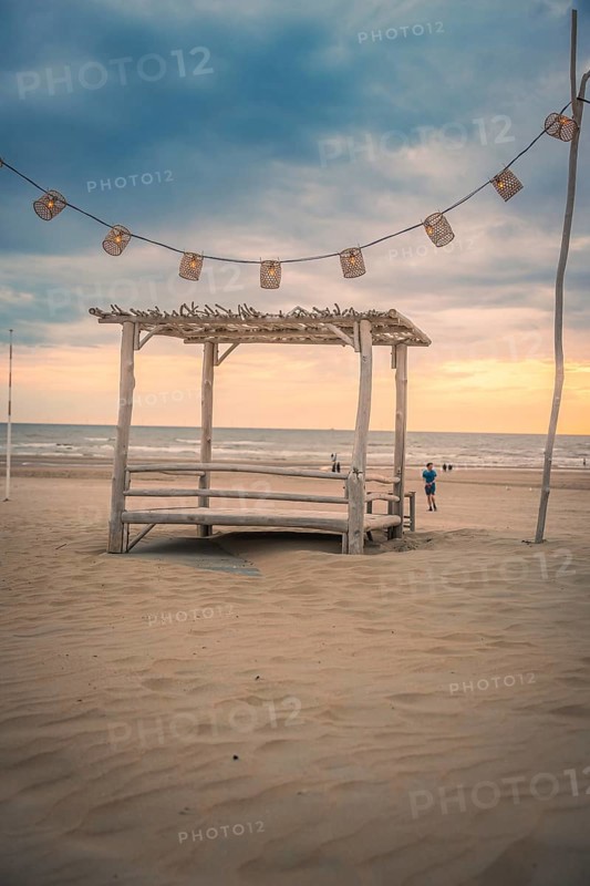 Fairy lights and wooden house on the beach at sunset, Zandvoort, Netherlands