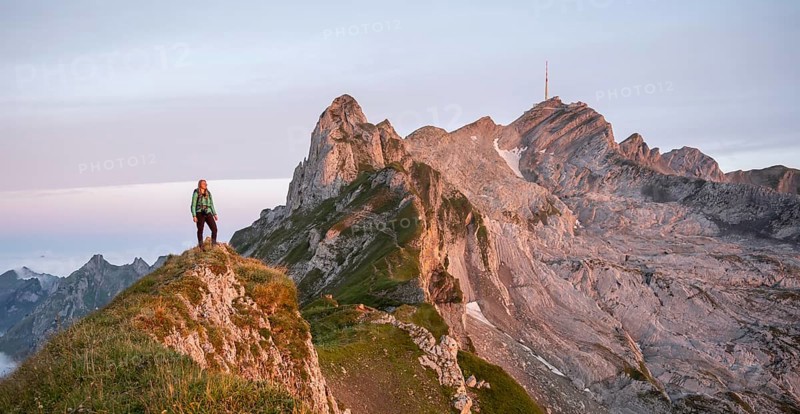 Hiker at the summit, mountains at sunrise, Säntis, Appenzell Ausserrhoden, Appenzell Alps, Switzerland, Europe