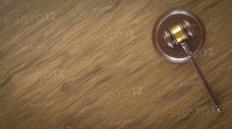 Overhead of gavel resting on a table with room for text