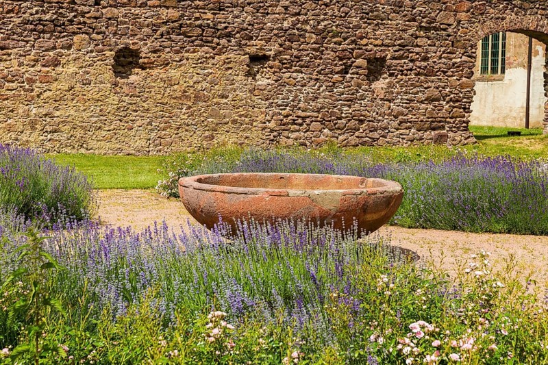 DEU Saxony Klosterbuch Area of the former cloister with Romanesque fountain bowl in the Kreugarten Buch Monastery is a former Cistercian monastery founded as St. Mary's Monastery in the 12th century. After the Reformation, it and its lands became a purely agricultural enterprise