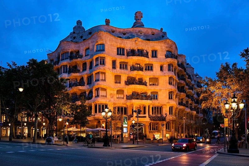 BARCELONA, SPAIN, APRIL 17, 2019: Night view of famous Casa Mila house know as La Pedrera modernist building in Barcelona, Catalonia, Spain designed by architect Antoni Gaudi
