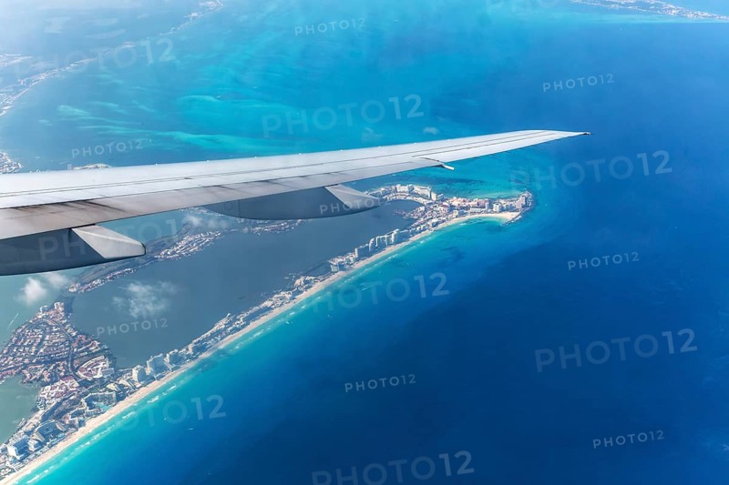 Aerial view through plane window of Caribbean coastline buildings in the hotel zone, Cancun, Quintana Roo, Yucatán Peninsula, Mexico, Central America