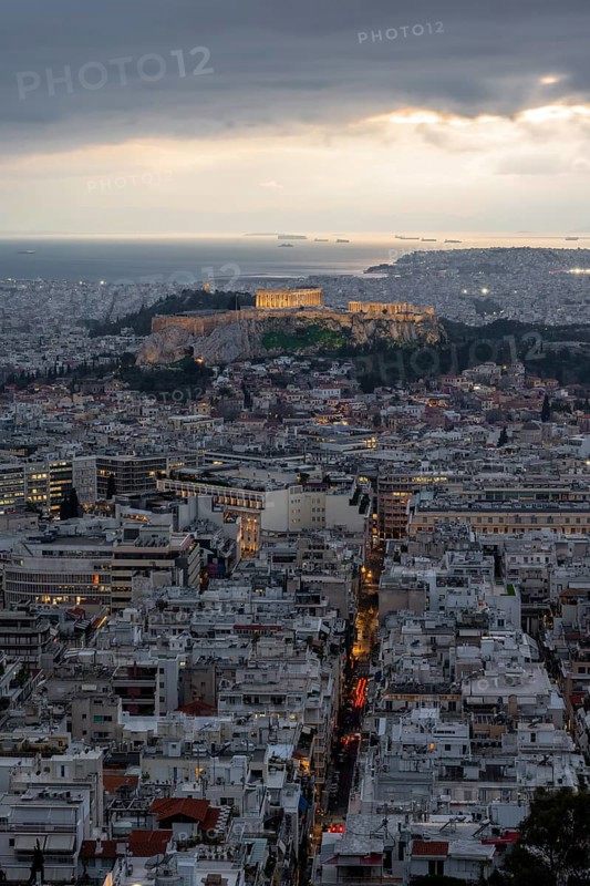 View over the sea of houses of Athens, illuminated Parthenon temple on the Acropolis, from Mount Lycabettus, Athens, Greece, Europe