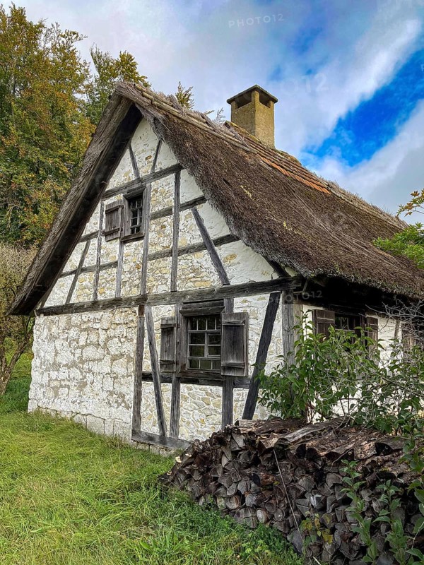 Historic reed thatched old rebuilt restored half-timbered house day labourer's house from Delkhofen in open-air museum Neuhausen, Neuhausen ob Eck, district Tuttlingen, Baden-Württemberg, Germany, Europe
