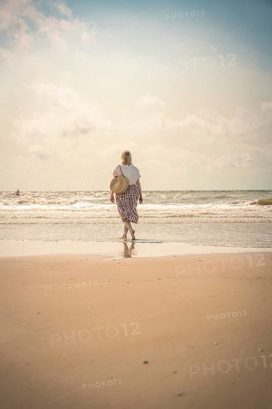 Woman on the beach in the evening sun, Zandvoort, Netherlands