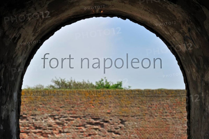 The pentagonal Fort Napoleon in the dunes near Ostend, Belgium. Viev over brick wall through window with lettering