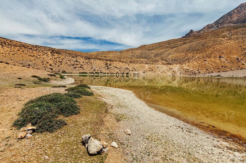 Himalayas mountains refelcting in mountain lake Dhankar Lake. Spiti Valley, Himachal Pradesh, India, Asia