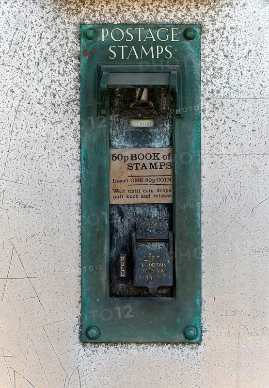 Old postage stamp coin machine no longer in use, UK