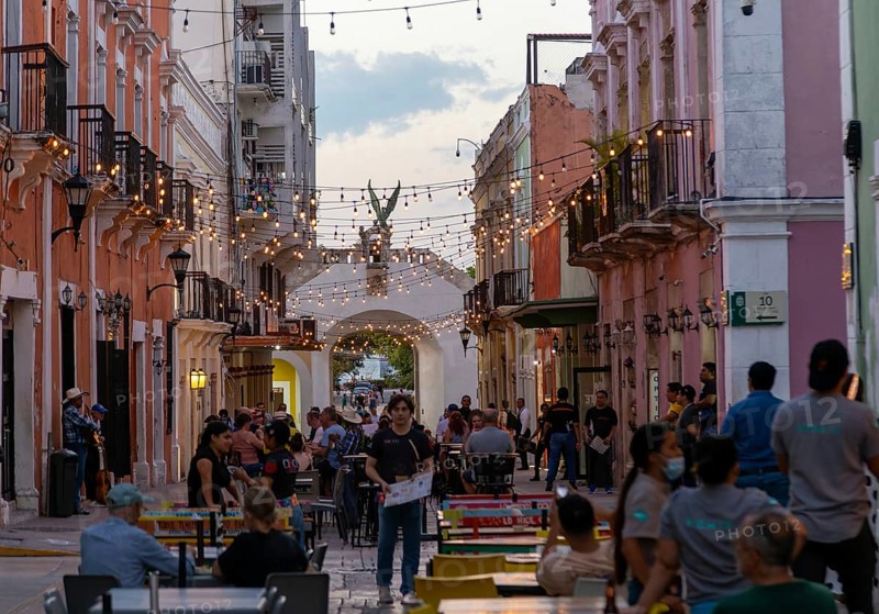 Restaurant tables in street at night with hanging lights, Campeche city, Campeche State, Mexico, Central America