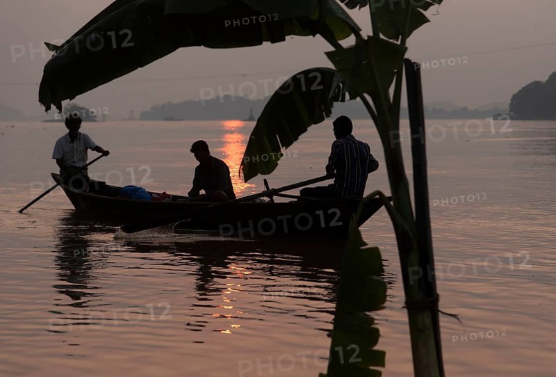 Fishermen boat passing next to a banana tree instralled for upcoming Chhath Puja festival, in the Brahmaputra river, in Guwahati on Thursday, 27 October 2022