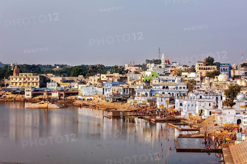 PUSHKAR, INDIA, NOVEMBER 20, 2012: Hindu devotees pilgrims bathing in sacred Puskhar lake (Sagar) on ghats of Pushkar, Rajasthan, India. Pushkar is holy city for Hinduists and famous for many Hindu temples