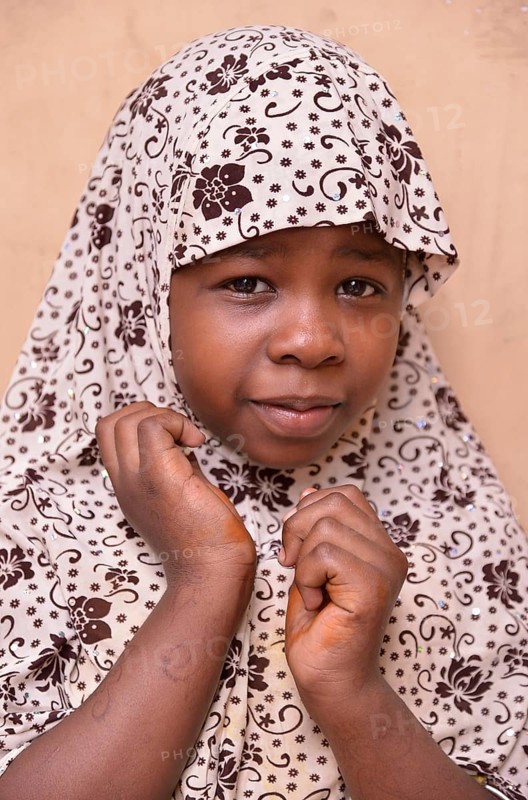 Girl wearing a headscarf, Stone Town, Zanzibar City, Zanzibar, Tanzania, Africa